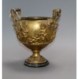 A gilt bronze two handled urn (lacking cover), depicting putti height 21.5cm