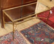 A rectangular glass and brass coffee table W.102cm