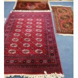 A Bokhara style rug and pair of Afghan rugs Largest 196 x 140cm