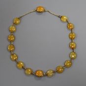 An Edwardian yellow metal and yellow agate choker necklace, which converts into two bracelets,