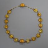 An Edwardian yellow metal and yellow agate choker necklace, which converts into two bracelets,