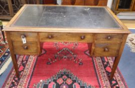 An early 20th century mahogany kneehole writing desk W.137cm