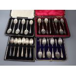Four cased sets of six late Victorian and later silver teaspoons including one with sugar tongs.