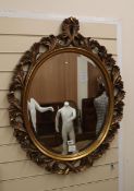 An oval leaf carved giltwood hall mirror and a circular convex mirror (2) Hall mirror H.92cm