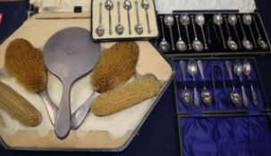 Three assorted sets of cased silver teaspoons spoons and a cased dressing table set.