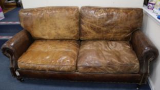 A pair of studded brown leather two seater settees W.200cm