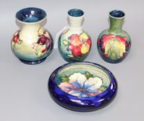 Three Moorcroft vases, in Lily and leaf and berry pattern and a similar dish (4)