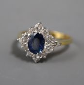 A modern 18ct gold, sapphire and diamond set cluster ring, of diamond form, size Q/R.