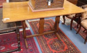 An early 20th century rectangular oak refectory dining table on carved end supports W.145cm