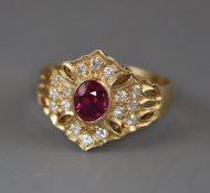 A modern pierced 14ct gold, ruby and diamond hexagonal cluster ring, size N/O.