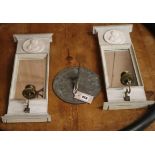 A pair of mirrored candle sconces and a sundial Sconces H.44cm