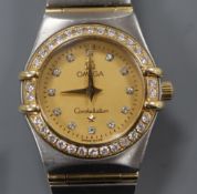 A lady's yellow metal, steel and diamond set Omega Constellation quartz wrist watch.