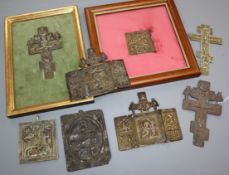 Eight 19th century Russian brass or copper crucifixes or icons