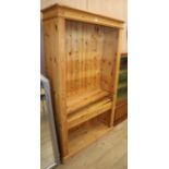 A reproduction pine open fronted bookcase W.103cm