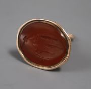 A 19th century yellow metal and carnelian set fob seal, the matrix carved with family crest (a.