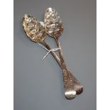 A pair of George III silver later embossed Old English pattern berry spoons, Godbehere & Wigan,