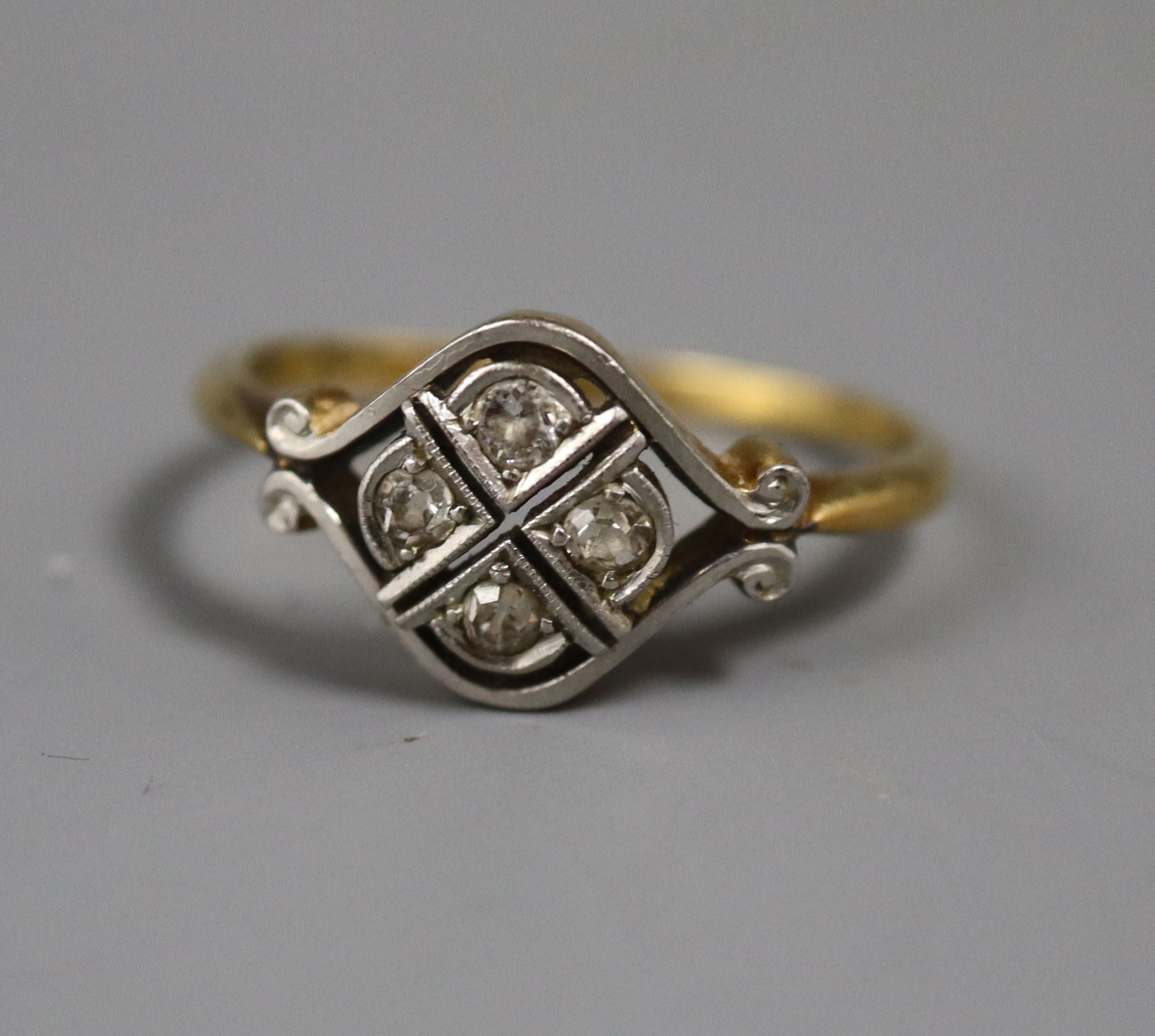 A 1920's 18ct & plat, four stone diamond set dress ring, size M.