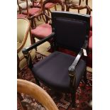 An ebonised Empire style elbow chair