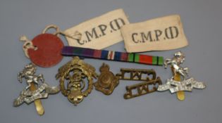 A collection of cap badges, etc.