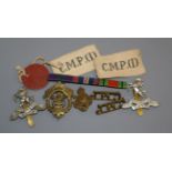 A collection of cap badges, etc.