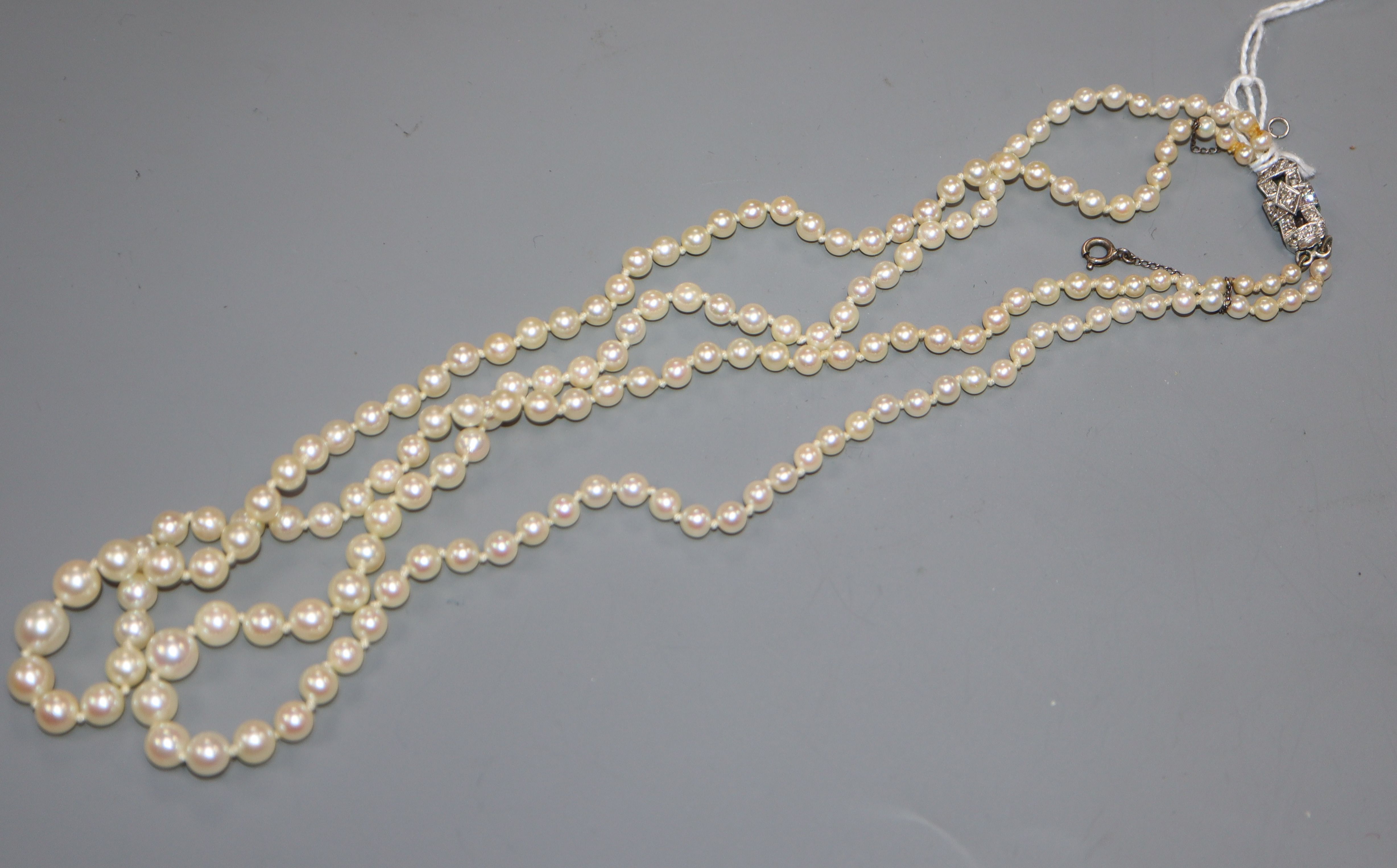 A double strand graduated culted pearl necklace with 9ct white metal and diamond set clasp, 44cm.