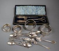 A silver bangle, three silver napkin rings, a small quantity of silver teaspoons and a cased