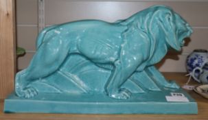 A turquoise glazed Art Deco pottery model of a lion width 44cm