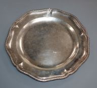 An 18th century French? shaped circular white metal dinner plate, with engraved border, 26.2cm.