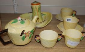 A Carltonware yellow ground teaset and sugar shaker