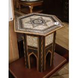A Moorish ebony and mother of pearl inlaid hexagonal table W.47cm