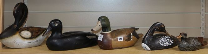 A collection of five painted palm wood decoy ducks