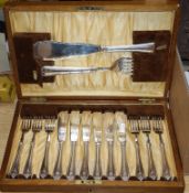 A set of oak cased silver plated fish knives and forks with servers