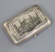 A late 19th century Russian 84 zolotnik silver and niello cigarette case, decorated with view of