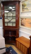 A Georgian mahogany standing corner cupboard, blind fret-carved and astragal-glazed over open