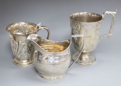 A George III silver cream jug, London, 1804 and two later silver christening mugs including