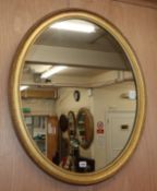 An Edwardian oval carved wood and gilt gesso wall mirror H.86cm