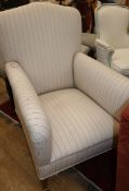 An Edwardian mahogany framed armchair, upholstered in a cream ground striped fabric