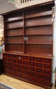 An Apothecaries dresser, fitted open shelves above a bank of forty small drawers W.174cm