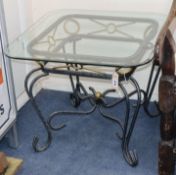A plate glass topped coffee table, with wrought iron base W.66cm