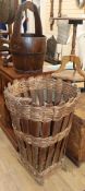 An Indian hardwood staved and coopered bucket, and a staved wicker bound log basket height 82cm