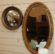 A late Victorian oval gilt framed wall mirror and a convex wall mirror (2) Convex mirror 33cm