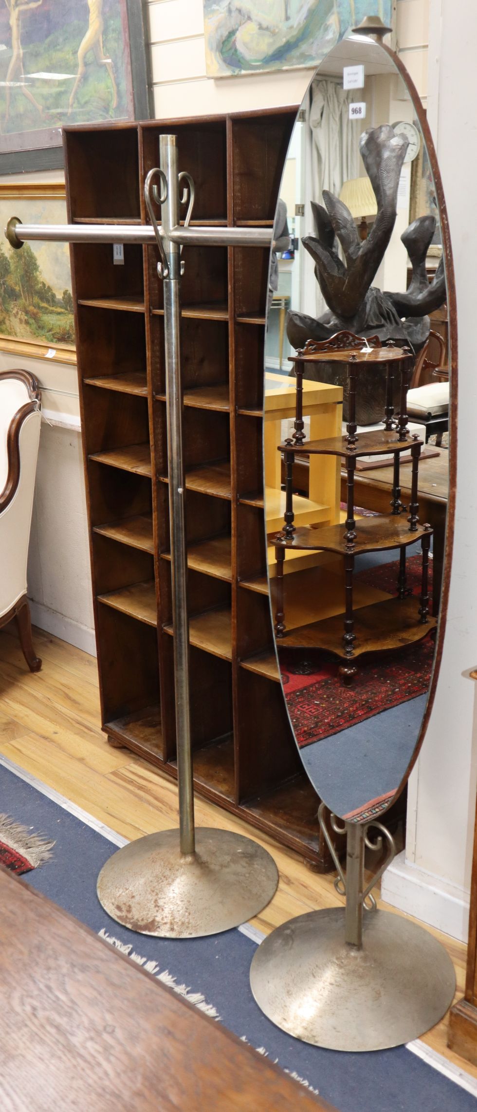 An elongated oval robing mirror, on chrome plated plinth, together with a similar hanging rail H.