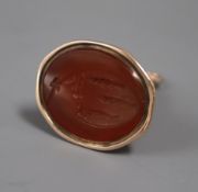 A 19th century yellow metal and carnelian set fob seal, the matrix carved with family crest (a.