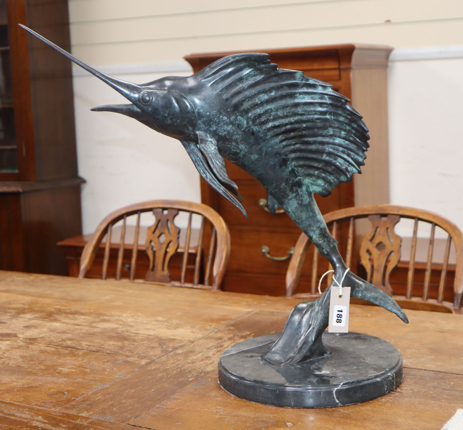 A 20th century bronze of a leaping sailfish on marble, circular plinth height 54cm