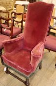 A Victorian upholstered high back scrolled armchair