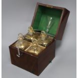 A George III mahogany cased set of four gilded glass decanters and a glass, with key