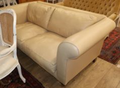 A putty coloured leather two seater settee