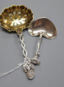 A Tiffany & Co sterling silver heart-shaped caddy spoon and a Tiffany strawberry sifter spoon with