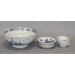 A Liverpool Delft blue and white bowl, decorated buildings and trees and three early tea bowls