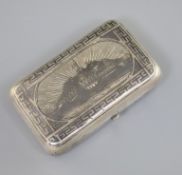 A late 19th century Russian 84 zolotnik silver and niello cigarette case, decorated with view of the